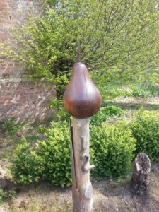 If you look realllly close, you'll see a ladybug on this wooden pear sculpture thingy